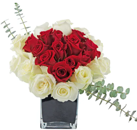 A red rose heart within a white rose heart will let them know you want to be together forever. One dozen of each color rose, arranged in a black cube, with eucalyptus accents. This bouquet is designed to impress, and to let flowers speak from your heart.