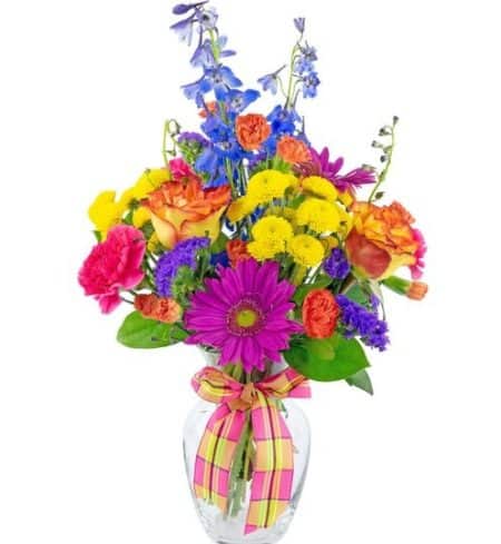 Hot summer colors abound in this great combination of your favorite flowers. Hot pink, orange, yellow and purple...gerbers, delphinium, roses, carnations, mini carnations and more. If making someone feel special is your plan, this bouquet is designed to do just that.