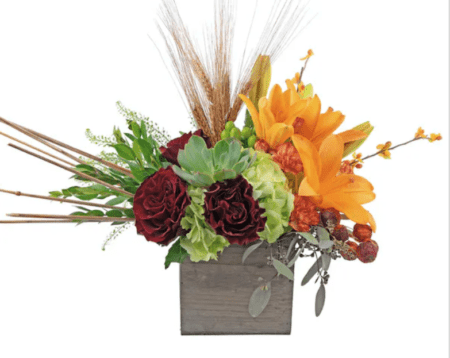 Hearts roses, green hydrangea, orange lilies and a succulent combine to create this stylish bouquet. The selection of Fall accents add to the overall look, designed to capture the Essence of Fall.