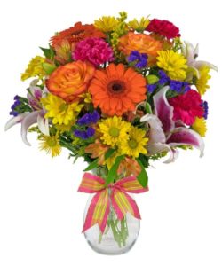 Bright, beautiful fresh flowers are arranged in a clear glass vase, and tied with a coordinating ribbon. Sunny Spirits combines konfetti roses, gerbera daisies, yellow daisies, hot pink carnations and other flowers for an all around brightly colored bouquet that is ideal for any occasion.