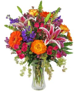 stargazer lilies, stock, konfetti roses, gerbera daisies, spray roses and alstromeria, with assorted greenery.