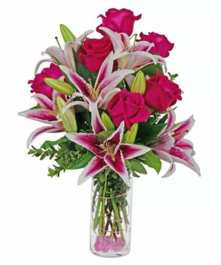 Hot pink roses are combined with stargazer lilies in a cylinder vase, and decorated with wire and gemstones. Elegantly simple, stylish, and very fragrant.